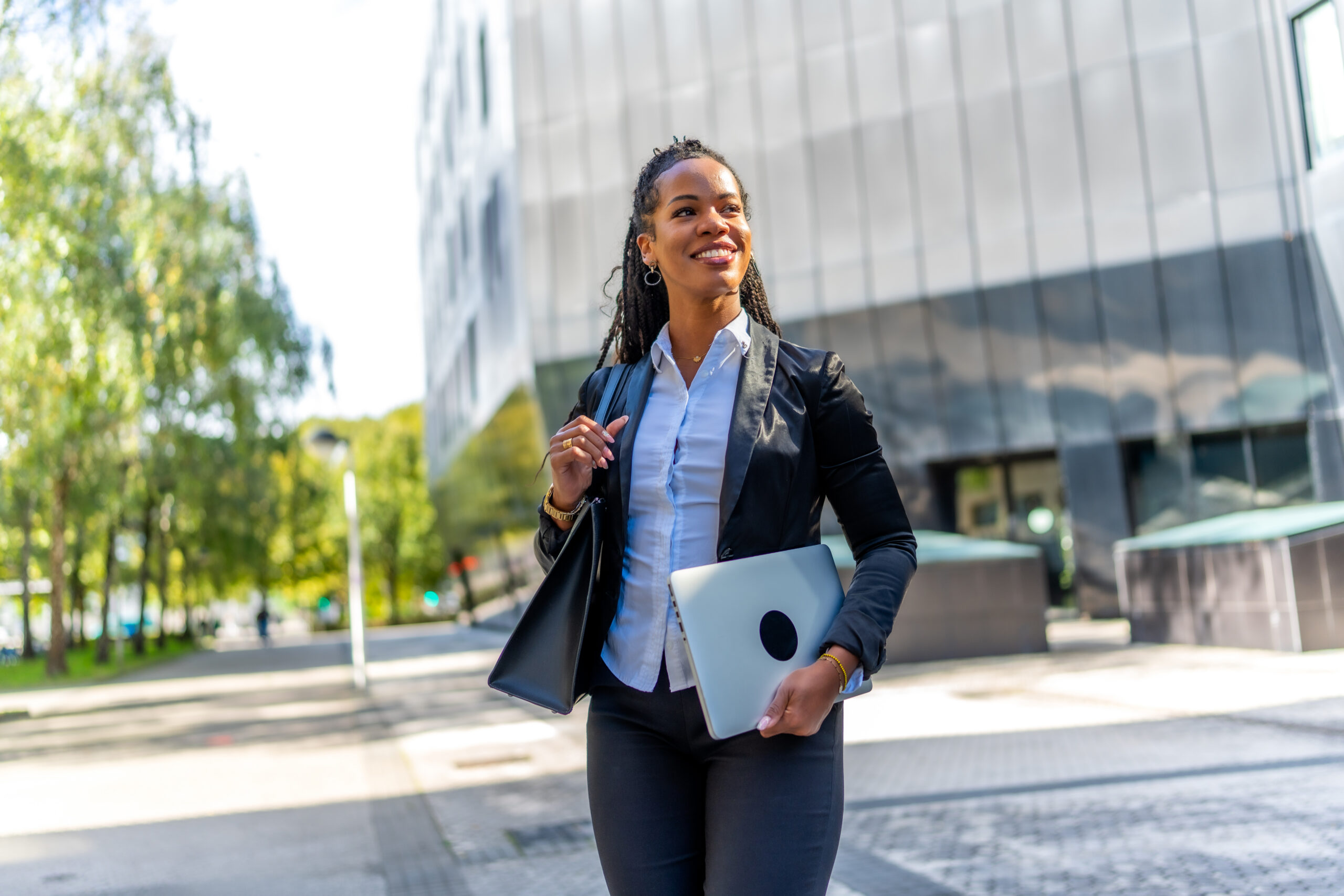 A confident sales representative walking outside.