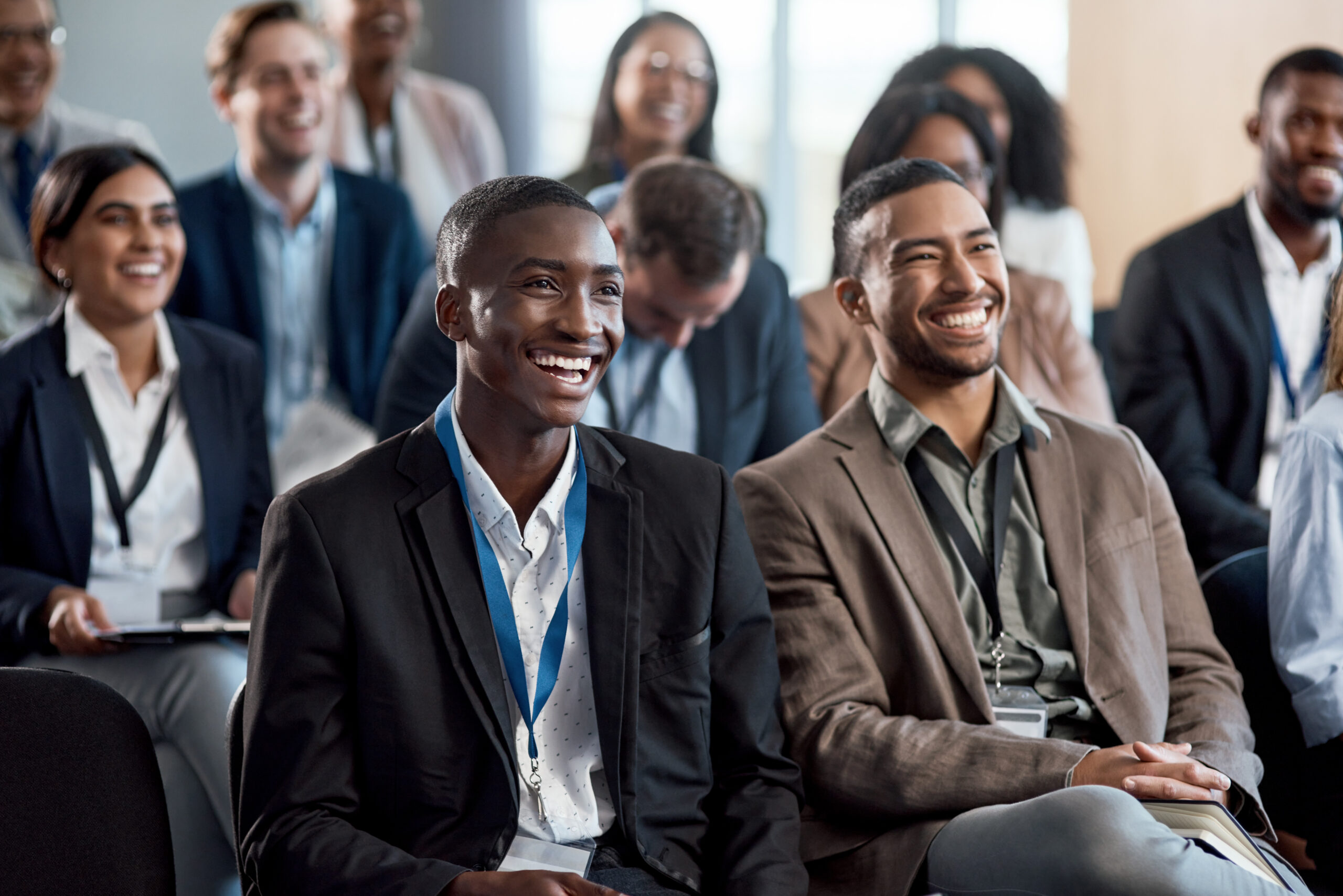 Young professionals smiling while attending a mentorship program.